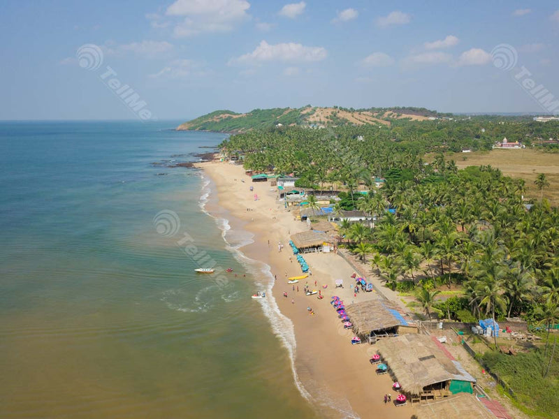 Aerial Delight: Anjuna Beach, Goa – Coconut Trees, Mountains, Tourists, and Village