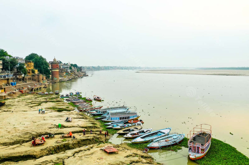 Aerial View of Assi Ghat, Varanasi: few people seen relaxing with Moored Boats in Banaras, Uttar Pradesh