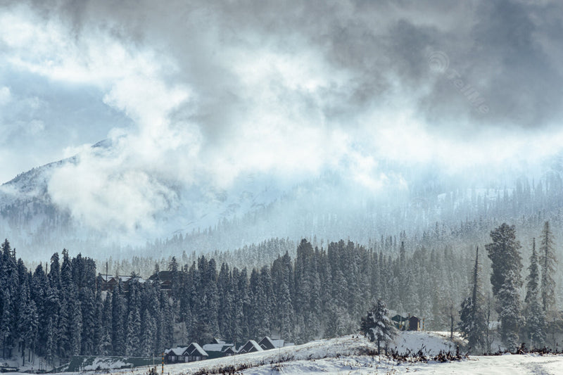 Winter Wonderland: A Serene Landscape of Snowy Houses, Pastures, Trees, and Peaks in Gulmarg, Kashmir, India