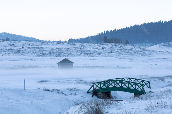 Snowscape Scene of Gulmarg with Bridge and Huts in Kashmir, India