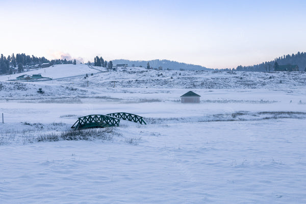 The winter landscape of Gulmarg, Kashmir is adorned with snow-covered bridges