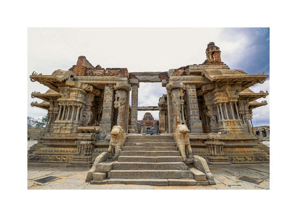 Walk up the steps to admire the Beautiful Pillars and Stone Carvings of a Ruined Ancient Temple in Hampi, Karnataka