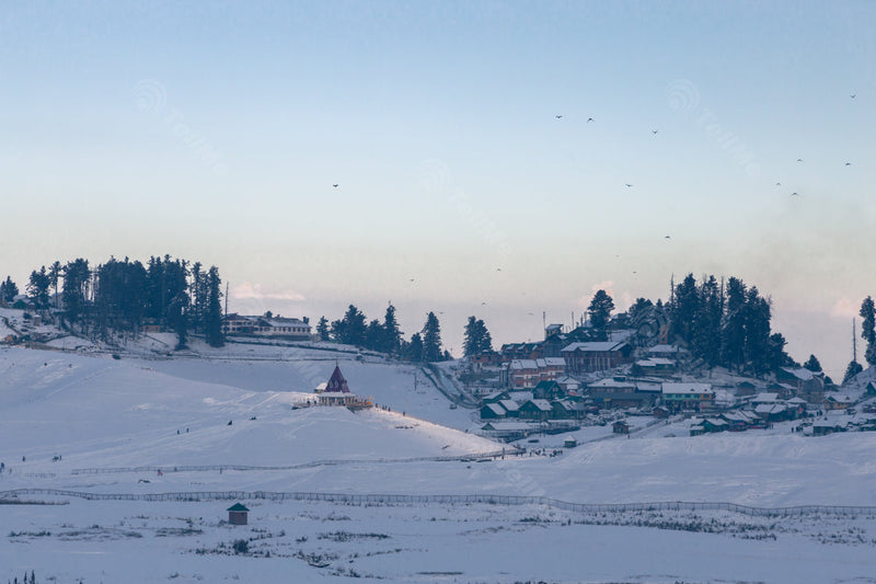 Snow-Capped Mohinishwar Temple with Gulmarg Town, Trees, and Snowy Landscape in Kashmir, India