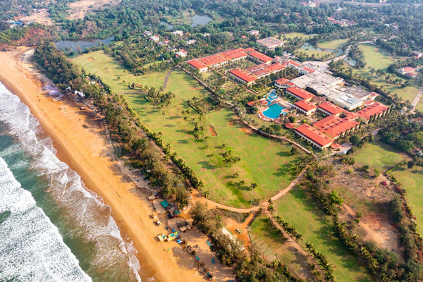 Seaside Serenity: Aerial Perspective of Rajbaga Beach, Resorts, and Relaxing Tourists in Goa