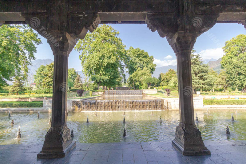 Nature's Oasis: Trees, Lawn, Waterfall, and Arches at Shalimar Bagh, Srinagar in Kashmir