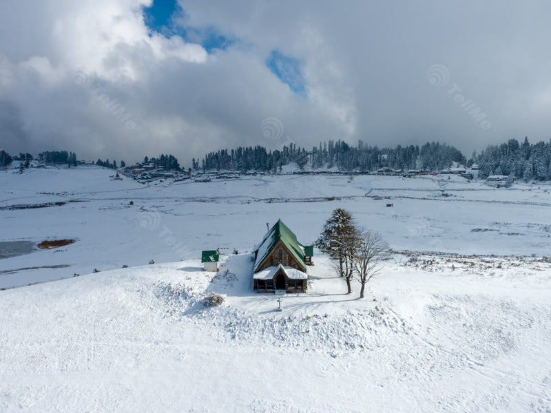 Cloud Shadows on Snowy Pasture with St Mary's Church and Trees in Gulmarg in Kashmir, India