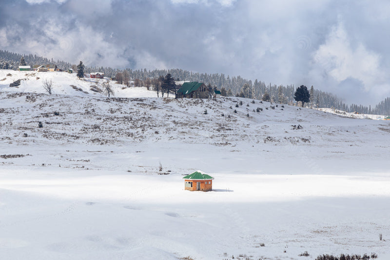 Snowy Pasture with Hut and St Mary's Church in Cloudy Weather in Gulmarg, Kashmir in India