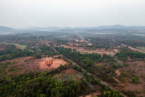 A Bird's Eye View of a Hot Air Balloon Drifting Over Goa's Verdant Pastures
